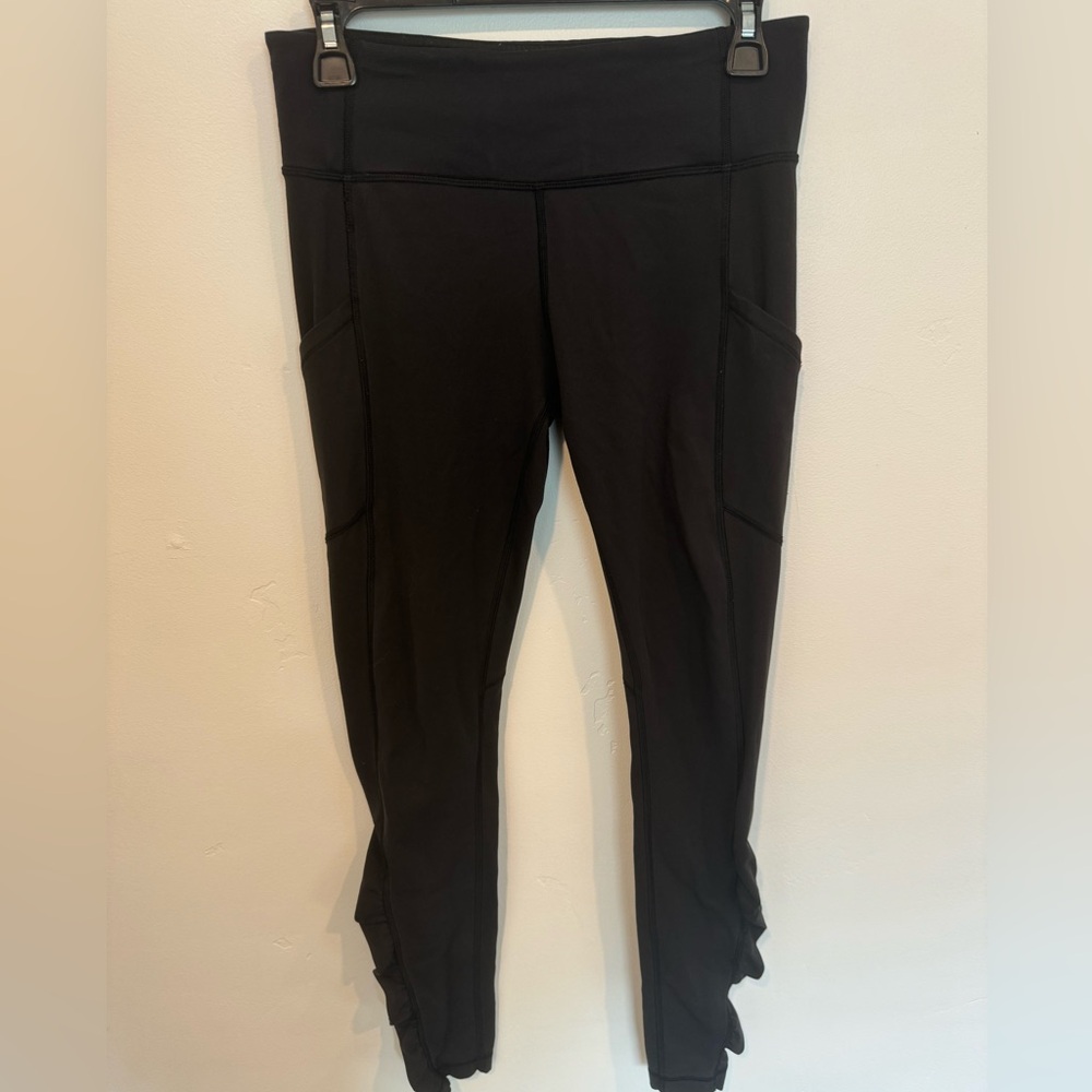 Lululemon size 6 black leggings with side pockets and ruching at bottom